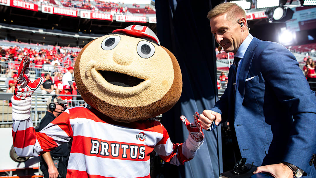 Brutus greets Joel Klatt before a NCAA football game between Iowa and Ohio State, Saturday, Oct. 22,