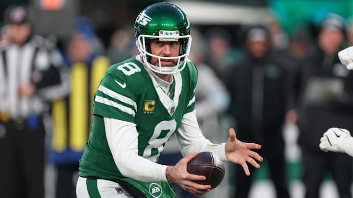Jan 5, 2025; East Rutherford, New Jersey, USA; New York Jets quarterback Aaron Rodgers (8) fakes a hand off during the first quarter against the Miami Dolphins at MetLife Stadium. Mandatory Credit: Vincent Carchietta-Imagn Images