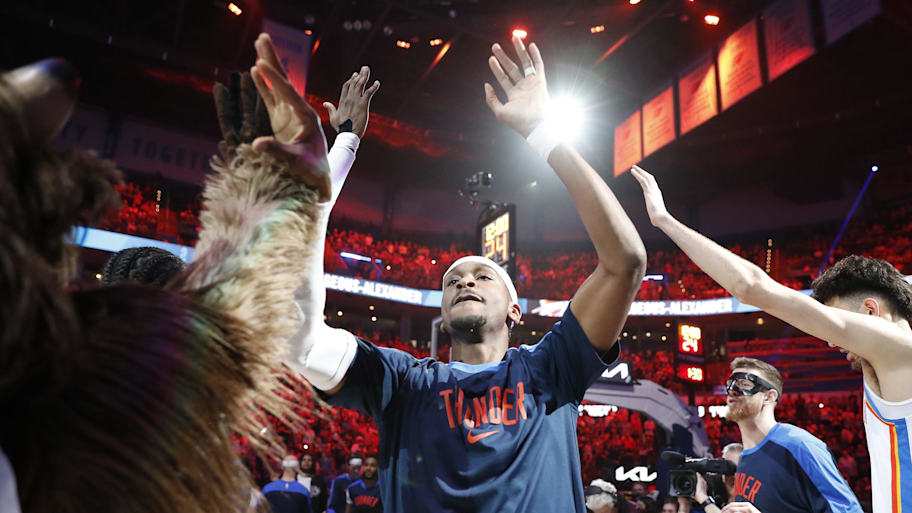 Oklahoma City Thunder guard Shai Gilgeous-Alexander high-fives his team during starting lineup introductions. | Alonzo Adams-Imagn Images