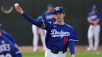 Los Angeles Dodger Roki Sasaki throws during a Spring Training workout.