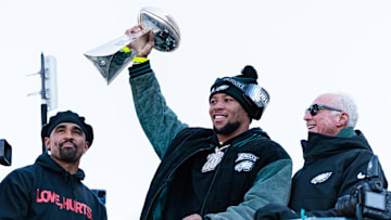 Philadelphia Eagles running back Saquon Barkley lifts the Lombardi Trophy during the Super Bowl LIX championship parade.