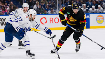 Jan 20, 2024; Vancouver, British Columbia, CAN; Toronto Maple Leafs defenseman Timothy Liljegren (37) and defenseman Jake McCabe (22) defend against Vancouver Canucks forward Dakota Joshua (81) in the third period at Rogers Arena. Canucks won 6-4. Mandatory Credit: Bob Frid-Imagn Images