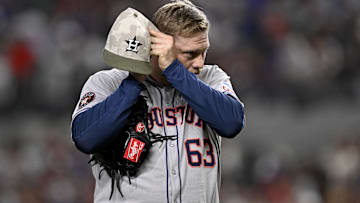 Houston Astros relief pitcher Kaleb Ort (63) checks his earpiece as he pitches against the Texas Rangers during the sixth inning at Globe Life Field.
