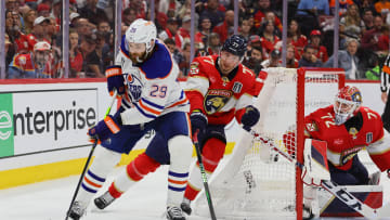Jun 24, 2024; Sunrise, Florida, USA; Edmonton Oilers forward Leon Draisaitl (29) controls the puck against Florida Panthers defenseman Niko Mikkola (77) during the third period in game seven of the 2024 Stanley Cup Final at Amerant Bank Arena. Mandatory Credit: Sam Navarro-USA TODAY Sports
