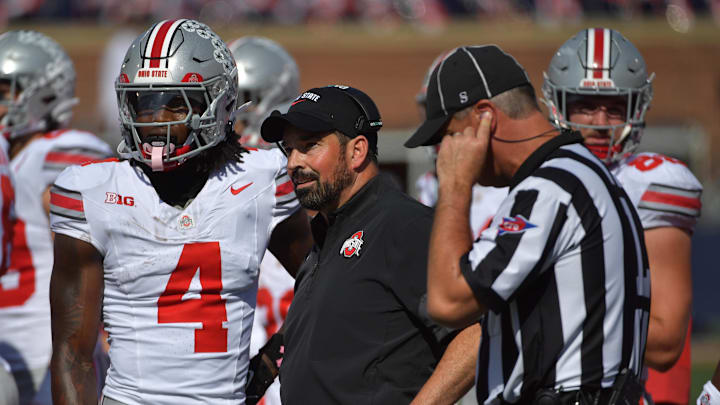Oct 11, 2025; Champaign, Illinois, USA; Ohio State Buckeyes head coach Ryan Day talks with wide receiver Jeremiah Smith (4) during the second quarter against the Illinois Fighting Illini at Memorial Stadium. Mandatory Credit: Ron Johnson-Imagn Images