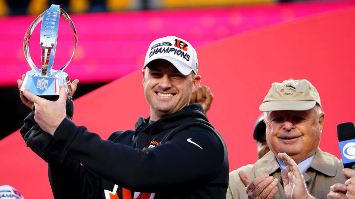 Cincinnati Bengals head coach Zac Taylor raises the AFC Championship trophy.