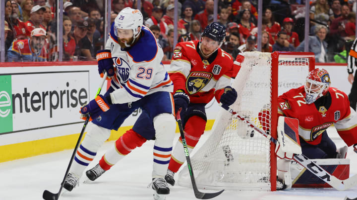 Jun 24, 2024; Sunrise, Florida, USA; Edmonton Oilers forward Leon Draisaitl (29) controls the puck against Florida Panthers defenseman Niko Mikkola (77) during the third period in game seven of the 2024 Stanley Cup Final at Amerant Bank Arena. Mandatory Credit: Sam Navarro-USA TODAY Sports