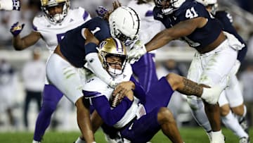 Nov 9, 2024; University Park, Pennsylvania, USA; Washington Huskies quarterback Demond Williams Jr (2) is tackled by Penn State Nittany Lions safety Jaylen Reed (1) during the third quarter at Beaver Stadium. Penn State won 35-6. Mandatory Credit: Matthew O'Haren-Imagn Images