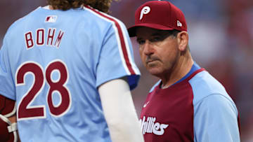  Philadelphia Phillies manager Rob Thomson (R) checks third base Alec Bohm (28) after an apparent injury during the first inning against the Atlanta Braves at Citizens Bank Park.