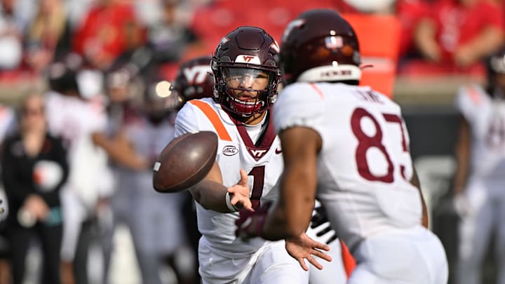 Nov 4, 2023; Louisville, Kentucky, USA;  Virginia Tech Hokies quarterback Kyron Drones (1) pitches the ball to wide receiver Jaylin Lane (83) during the first half against the Louisville Cardinals at L&N Federal Credit Union Stadium. Louisville defeated Virginia Tech 34-3. Mandatory Credit: Jamie Rhodes-Imagn Images