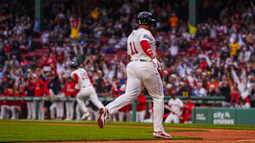 Jun 10, 2025; Boston, Massachusetts, USA; Boston Red Sox odesignated hitter Rafael Devers (11) scores as utfielder Roman Anthony (19) hits a double to drive in two runs against the Tampa Bay Rays in the first inning at Fenway Park.
