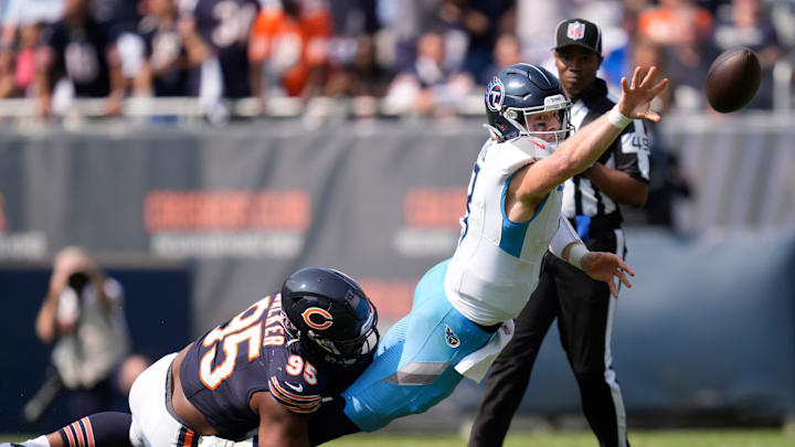 Tennessee Titans quarterback Will Levis (8) flips the ball to avoid a sack by Chicago Bears defensive end DeMarcus Walker (95) but wound up with an interception during the fourth quarter at Soldier Field in Chicago, Ill., Sunday, Sept. 8, 2024.