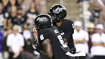 Oct 26, 2024; College Station, Texas, USA; Texas A&M Aggies quarterback Marcel Reed (10) hands off the ball to running back Le'Veon Moss (8) during the fourth quarter against the LSU Tigers. The Aggies defeated the Tigers 38-23; at Kyle Field. Mandatory Credit: Maria Lysaker-Imagn Images.  