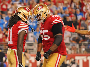 San Francisco 49ers wide receiver Brandon Aiyuk (11) celebrates with guard Aaron Banks (65) after scoring a touchdown against the Detroit Lions 