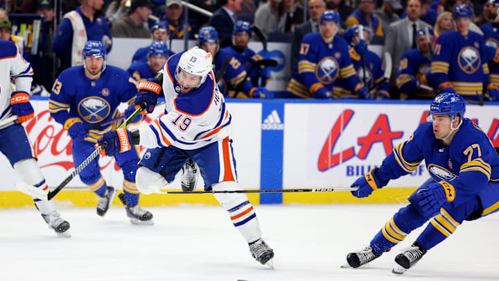 Mar 9, 2024; Buffalo, New York, USA;  Buffalo Sabres right wing JJ Peterka (77) knocks the puck off the stick of Edmonton Oilers center Adam Henrique (19) as he takes a shot during the first period at KeyBank Center. Mandatory Credit: Timothy T. Ludwig-USA TODAY Sports