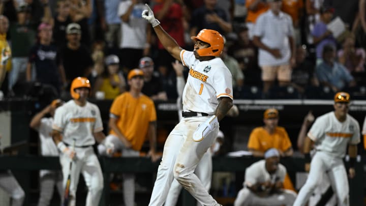 Jun 14, 2024; Omaha, NE, USA;  Tennessee Volunteers second baseman Christian Moore (1) celebrates scoring the tying run against the Florida State Seminoles during the ninth inning at Charles Schwab Filed Omaha. Mandatory Credit: Steven Branscombe-USA TODAY Sports
