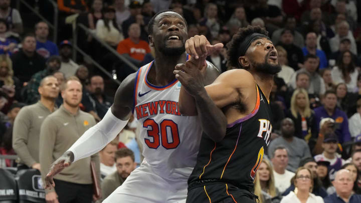 Dec 15, 2023; Phoenix, Arizona, USA; New York Knicks forward Julius Randle (30) and Phoenix Suns guard Jordan Goodwin (0) battle for the ball in the second half at Footprint Center. Mandatory Credit: Rick Scuteri-USA TODAY Sports