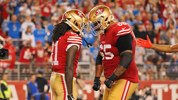 San Francisco 49ers wide receiver Brandon Aiyuk (11) celebrates with guard Aaron Banks (65) after scoring a touchdown against the Detroit Lions 