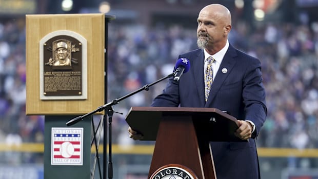 Colorado Rockies former right fielder Larry Walker wears a suit and tie while speaking to fans at Coors Field.
