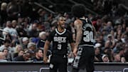 Nov 19, 2024; San Antonio, Texas, USA;  San Antonio Spurs guard Chris Paul (3) and forward Julian Champagnie (30) celebrate in the second half against the Oklahoma City Thunder at Frost Bank Center. Mandatory Credit: Daniel Dunn-Imagn Images