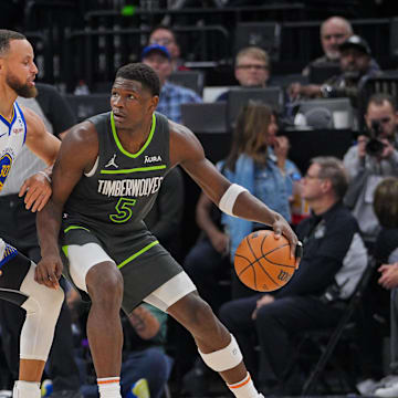 Mar 24, 2024; Minneapolis, Minnesota, USA; Golden State Warriors guard Stephen Curry (30) defends Minnesota Timberwolves guard Anthony Edwards (5) in the third quarter at Target Center. Mandatory Credit: Brad Rempel-Imagn Images