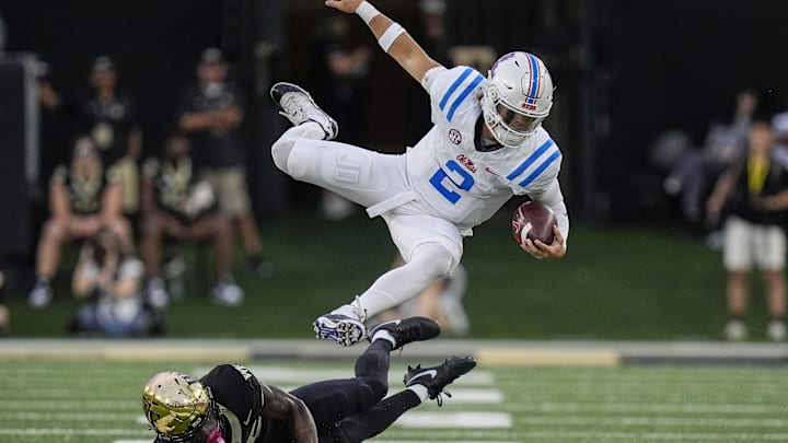 Sep 14, 2024; Winston-Salem, North Carolina, USA;  Wake Forest Demon Deacons defensive back Jamare Glasker (25) upends Mississippi Rebels quarterback Jaxson Dart (2) during the first half at Allegacy Federal Credit Union Stadium. Mandatory Credit: Jim Dedmon-Imagn Images