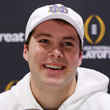 Jan 18, 2025; Atlanta, GA, USA; Notre Dame Fighting Irish quarterback Riley Leonard (13) talks to the media during 2025 CFP National Championship Media Day at Georgia World Congress Center, Building A.