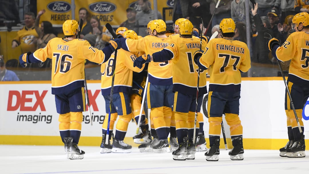 Apr 8, 2025; Nashville, Tennessee, USA;  Nashville Predators center Fedor Svechkiv (40) celebrates his game=winning goal with his teammates  during the over time period at Bridgestone Arena. Mandatory Credit: Steve Roberts-Imagn Images