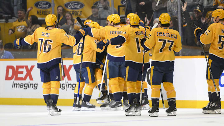 Apr 8, 2025; Nashville, Tennessee, USA;  Nashville Predators center Fedor Svechkiv (40) celebrates his game=winning goal with his teammates  during the over time period at Bridgestone Arena. Mandatory Credit: Steve Roberts-Imagn Images