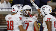 New Mexico Lobos tight end Dorian Thomas (7) receives congratulations from teammates.
