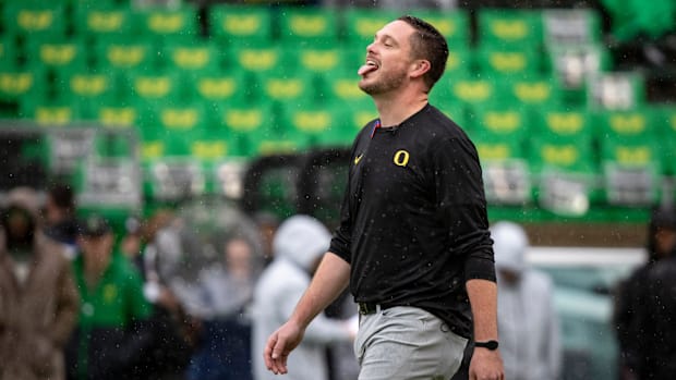 Oregon head coach Dan Lanning sticks his tongue out to catch the rain as the No. 6 Oregon Ducks host California Saturday, Nov