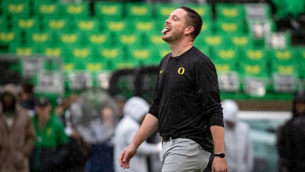 Oregon head coach Dan Lanning sticks his tongue out to catch the rain as the No. 6 Oregon Ducks host California.