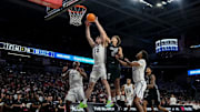 Xavier Musketeers forward Zach Freemantle (32) pulls in a rebound ahead of Cincinnati Bearcats guard Dan Skillings Jr. (0) in the second half of the 92nd Annual Crosstown Shootout NCAA basketball game between the Cincinnati Bearcats and the Xavier Musketeers at Fifth Third Arena on the UC campus in Cincinnati on Saturday, Dec. 14, 2024. The Bearcats won 68-65.