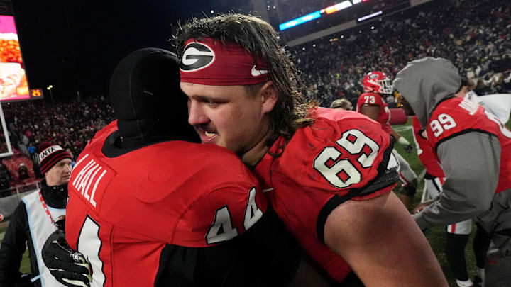 Georgia defensive lineman Jordan Hall (44) and Georgia offensive lineman Tate Ratledge (69) celebrate after winning a NCAA college football game against Georgia Tech in overtime in Athens, Ga., on Friday, Nov. 29, 2024. Georgia won 44-42. Georgia defensive lineman Jordan Hall (44) and Georgia offensive lineman Tate Ratledge (69) celebrate after winning a NCAA college football game against Georgia Tech in overtime in Athens, Ga., on Friday, Nov. 29, 2024. Georgia won 44-42.