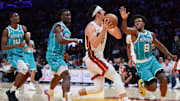 Oct 28, 2025; Miami, Florida, USA; Miami Heat guard Jaime Jaquez Jr. (11) drives to the basket against Charlotte Hornets guard Collin Sexton (8) during the fourth quarter at Kaseya Center. Mandatory Credit: Sam Navarro-Imagn Images