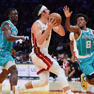 Oct 28, 2025; Miami, Florida, USA; Miami Heat guard Jaime Jaquez Jr. (11) drives to the basket against Charlotte Hornets guard Collin Sexton (8) during the fourth quarter at Kaseya Center. Mandatory Credit: Sam Navarro-Imagn Images