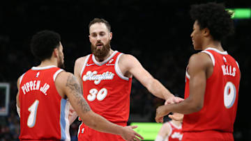 Nov 17, 2024; Memphis, Tennessee, USA; Memphis Grizzlies center Jay Huff (30) reacts with guard Scotty Pippen Jr. (1) and forward Jaylen Wells (0) during the second half against the Denver Nuggets at FedExForum. Mandatory Credit: Petre Thomas-Imagn Images