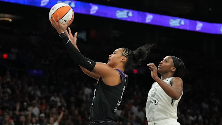 Aug 15, 2025; Phoenix, Arizona, USA; Phoenix Mercury forward Satou Sabally (0) drives by Las Vegas Aces guard Jackie Young (0) in the second half at Footprint Center. Mandatory Credit: Rick Scuteri-Imagn Images