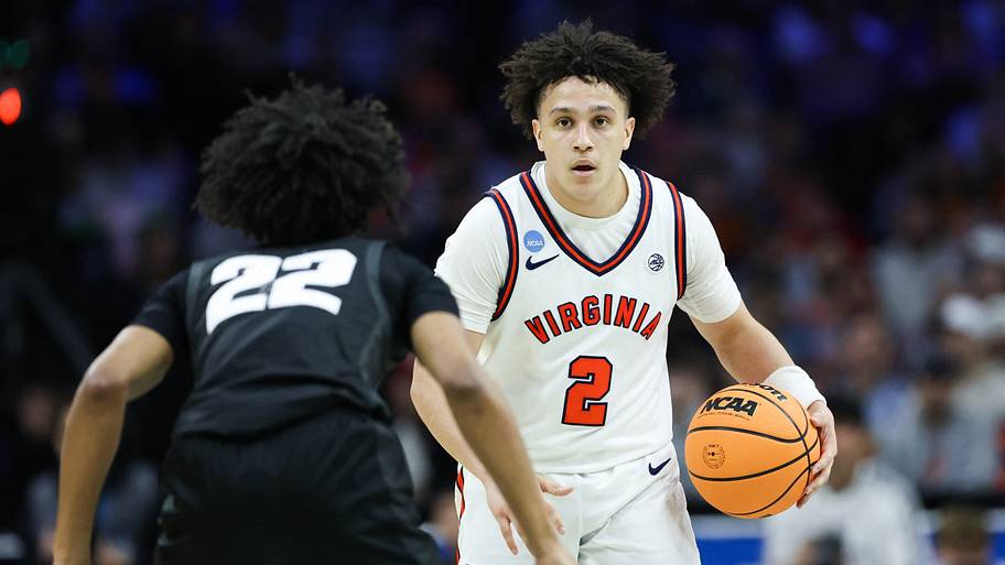 Virginia’s Chance Mallory looks to pass as Wright State guard TJ Burch defends.