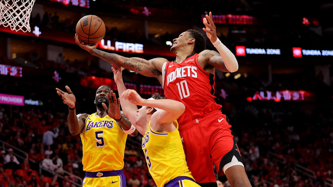 May 1, 2026; Houston, Texas, USA; Houston Rockets forward Jabari Smith Jr. (10) rebounds against Los Angeles Lakers guard Austin Reaves (15) during the first quarter game six of the first round of the 2026 NBA Playoffs at Toyota Center. Mandatory Credit: Erik Williams-Imagn Images
