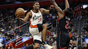 Nov 25, 2024; Detroit, Michigan, USA;  Detroit Pistons guard Jaden Ivey (23) shoots on Toronto Raptors forward Jonathan Mogbo (2) in the first half at Little Caesars Arena. Mandatory Credit: Rick Osentoski-Imagn Images
