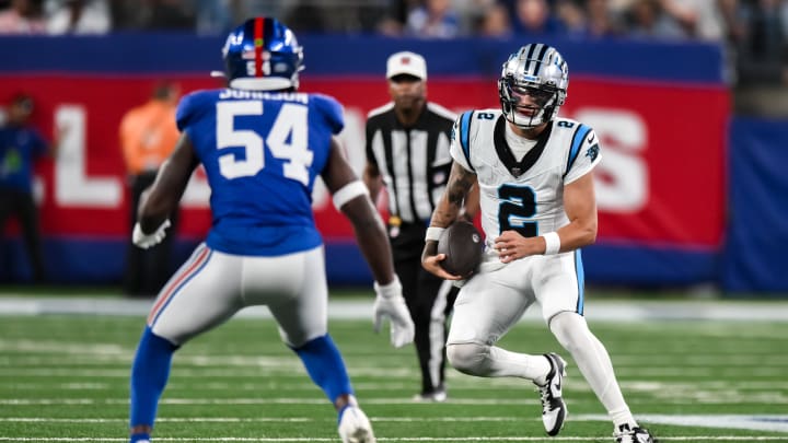 Aug 18, 2023; East Rutherford, New Jersey, USA; Carolina Panthers quarterback Matt Corral (2) tries to get past New York Giants linebacker Dyontae Johnson (54) during the third quarter at MetLife Stadium.  