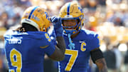 Oct 4, 2025; Pittsburgh, Pennsylvania, USA;  Pittsburgh Panthers linebacker Kyle Louis (9) celebrates his fumble recovery with defensive back Javon McIntyre (7) against the Boston College Eagles during the second quarter at Acrisure Stadium. Mandatory Credit: Charles LeClaire-Imagn Images