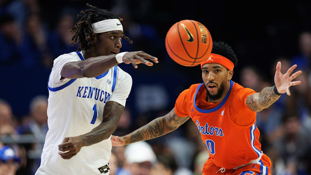 Mar 7, 2026; Lexington, Kentucky, USA; Kentucky Wildcats guard Denzel Aberdeen (1) passes the ball around Florida Gators guard Boogie Fland (0) during the first half at Rupp Arena at Central Bank Center. Mandatory Credit: Jordan Prather-Imagn Images
