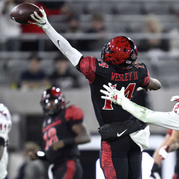 Nov 25, 2023; San Diego, California, USA; San Diego State Aztecs wide receiver Phillippe Wesley II (14) attempts to make a catch ahead of Fresno State Bulldogs defensive back Dean Clark (32) during the first half at Snapdragon Stadium. Mandatory Credit: Orlando Ramirez-USA TODAY Sports