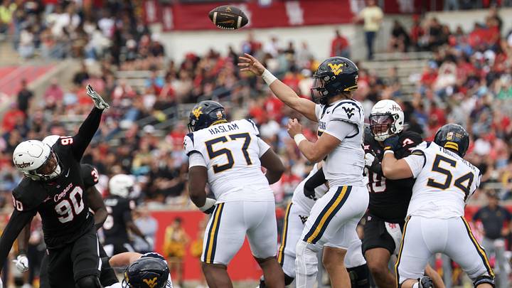 Nov 1, 2025; Houston, Texas, USA;  West Virginia Mountaineers quarterback Scotty Fox Jr. (15) passes against Houston Cougars defensive lineman Eddie Walls III (90) in the first half at TDECU Stadium. Mandatory Credit: Thomas Shea-Imagn Images