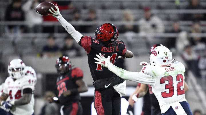 Nov 25, 2023; San Diego, California, USA; San Diego State Aztecs wide receiver Phillippe Wesley II (14) attempts to make a catch ahead of Fresno State Bulldogs defensive back Dean Clark (32) during the first half at Snapdragon Stadium. Mandatory Credit: Orlando Ramirez-USA TODAY Sports
