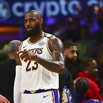 Mar 22, 2025; Los Angeles, California, USA; Los Angeles Lakers guard Luka Doncic (77) and Los Angeles Lakers forward LeBron James (23) on the sidelines against the Chicago Bulls during the first half at Crypto.com Arena. Mandatory Credit: Jonathan Hui-Imagn Images