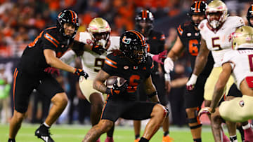Oct 26, 2024; Miami Gardens, Florida, USA; Miami Hurricanes running back Damien Martinez (6) runs with the football against the Florida State Seminoles during the second quarter at Hard Rock Stadium. Mandatory Credit: Sam Navarro-Imagn Images