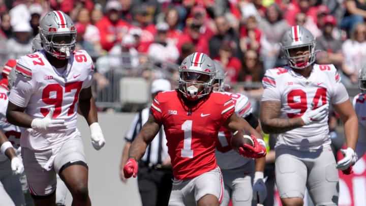 April 13, 2024; Columbus, Ohio, USA; 
Ohio State Buckeyes running back Quinshon Judkins (1) runs the football for the scarlet team while pursued by defensive end Kenyatta Jackson Jr. (97) and Jason Moore (94) of the grey team during the first half of the LifeSports spring football game at Ohio Stadium on Saturday.